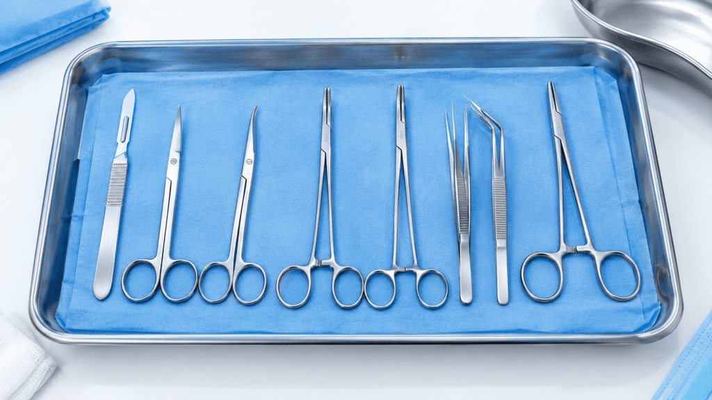stainless steel surgical instruments arranged on a sterile tray